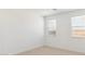 Well-lit bedroom features neutral carpet, two windows, and fresh paint at 7369 W Buckhorn Trl, Peoria, AZ 85383