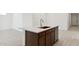 Modern kitchen island featuring sink, cabinets and stainless steel dishwasher at 7369 W Buckhorn Trl, Peoria, AZ 85383