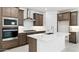Modern kitchen with stainless steel vent hood and large center island at 7369 W Buckhorn Trl, Peoria, AZ 85383