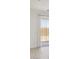 Bright, airy living room with sliding glass door access to the backyard and neutral tile flooring at 7369 W Buckhorn Trl, Peoria, AZ 85383