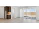 Bright living room with sliding glass door access to the backyard and neutral tile flooring at 7369 W Buckhorn Trl, Peoria, AZ 85383
