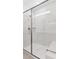 Modern tiled shower boasts glass doors and a built-in shelf at 7369 W Buckhorn Trl, Peoria, AZ 85383