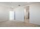 Bright bedroom with plush carpet, recessed lighting, and convenient hallway access at 7398 W Buckhorn Trl, Peoria, AZ 85383