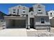 Two-story home showing gray stucco exterior with a 2-car garage awaiting finishing touches at 7398 W Buckhorn Trl, Peoria, AZ 85383