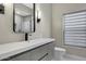 Modern bathroom with a sleek vanity, black hardware, and a large mirror at 7525 E Gainey Ranch Rd # 118, Scottsdale, AZ 85258