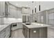 Modern kitchen with gray cabinets, a large island, stainless steel appliances, and stylish pendant lighting at 7525 E Gainey Ranch Rd # 118, Scottsdale, AZ 85258