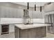 Bright kitchen featuring a large island with a white countertop and modern gray cabinetry at 7525 E Gainey Ranch Rd # 118, Scottsdale, AZ 85258