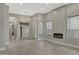 Spacious living area with wood-look flooring, a modern fireplace, and ample natural light from large windows at 7525 E Gainey Ranch Rd # 118, Scottsdale, AZ 85258