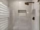 Modern bathroom shower with gray tiled walls, a built-in niche, and a sleek showerhead at 7525 E Gainey Ranch Rd # 118, Scottsdale, AZ 85258