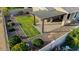 Aerial view of a beautifully landscaped backyard featuring a pergola and green lawn at 7618 S Lone Pine Pl, Gold Canyon, AZ 85118