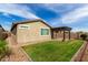 Well-maintained backyard with a pergola, green lawn, and desert landscaping at 7618 S Lone Pine Pl, Gold Canyon, AZ 85118