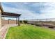 Scenic backyard featuring a green lawn, patio with pergola, and desert views at 7618 S Lone Pine Pl, Gold Canyon, AZ 85118