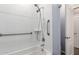 Bright bathroom featuring a shower-tub combo with white tiling and convenient grab bars at 7618 S Lone Pine Pl, Gold Canyon, AZ 85118