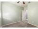 A carpeted bedroom showcasing its open layout and a decorative wall hanging at 7618 S Lone Pine Pl, Gold Canyon, AZ 85118