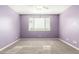 Spacious bedroom with carpet flooring, large window, and calming purple walls at 7618 S Lone Pine Pl, Gold Canyon, AZ 85118