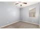 Neutral bedroom with a ceiling fan, window with blinds, and soft carpet flooring at 7618 S Lone Pine Pl, Gold Canyon, AZ 85118