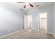 Carpeted bedroom with ceiling fan, closet, and light blue walls at 7618 S Lone Pine Pl, Gold Canyon, AZ 85118