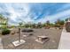 Picnic tables and cornhole boards are located in a common community space at 7618 S Lone Pine Pl, Gold Canyon, AZ 85118