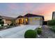 Charming single-Gathering home with well-maintained landscaping and inviting curb appeal at dusk at 7618 S Lone Pine Pl, Gold Canyon, AZ 85118