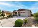 Attractive single-story home with manicured landscaping and spacious driveway leading to a two-car garage at 7618 S Lone Pine Pl, Gold Canyon, AZ 85118