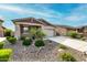 Inviting single-story home featuring desert landscaping, a covered porch, and a two-car garage at 7618 S Lone Pine Pl, Gold Canyon, AZ 85118