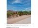 Desert hotel entrance with rustic signage and scenic mountain backdrop for a peaceful experience at 7618 S Lone Pine Pl, Gold Canyon, AZ 85118