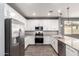 Open kitchen featuring stainless steel appliances, granite counters, and ample cabinet space at 7618 S Lone Pine Pl, Gold Canyon, AZ 85118