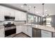 Bright kitchen featuring stainless steel appliances, granite countertops, and white cabinetry at 7618 S Lone Pine Pl, Gold Canyon, AZ 85118