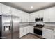 Modern kitchen featuring stainless steel appliances, granite countertops, and ample cabinet space at 7618 S Lone Pine Pl, Gold Canyon, AZ 85118