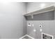 Functional laundry room with overhead shelving and utility connections at 7618 S Lone Pine Pl, Gold Canyon, AZ 85118