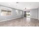 Open-concept living room featuring hardwood floors, ample natural light, and ceiling fan at 7618 S Lone Pine Pl, Gold Canyon, AZ 85118
