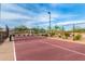 View of a well maintained pickleball court with a net and a fence at 7618 S Lone Pine Pl, Gold Canyon, AZ 85118