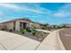 Pleasant neighborhood street with well-maintained landscaping, sidewalks, and a view of the mountains at 7618 S Lone Pine Pl, Gold Canyon, AZ 85118