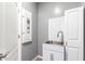 A functional utility sink and cabinet provide washing and storage space at 7618 S Lone Pine Pl, Gold Canyon, AZ 85118