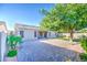 Backyard featuring a large paver patio, mature tree, and well-maintained landscaping at 853 E Ivanhoe Ct, Gilbert, AZ 85295