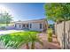 Expansive backyard with a covered patio, well-manicured lawn, and desert landscaping, perfect for outdoor living at 853 E Ivanhoe Ct, Gilbert, AZ 85295