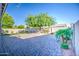 Spacious backyard featuring paver patio, mature trees, and lush landscaping at 853 E Ivanhoe Ct, Gilbert, AZ 85295