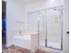 Bright bathroom featuring a glass-enclosed shower and a relaxing soaking tub at 853 E Ivanhoe Ct, Gilbert, AZ 85295