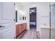 Bathroom with wood cabinets, double sinks, and access to the main bedroom at 853 E Ivanhoe Ct, Gilbert, AZ 85295