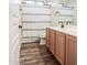 Well-lit bathroom featuring double sinks, wood-look floor, and a shower-tub combination at 853 E Ivanhoe Ct, Gilbert, AZ 85295