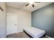 Bedroom features neutral walls, a ceiling fan, and a large window for natural light at 853 E Ivanhoe Ct, Gilbert, AZ 85295