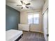 Cozy bedroom with a ceiling fan, neutral walls, large window and a closet at 853 E Ivanhoe Ct, Gilbert, AZ 85295