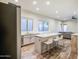 Eat-in kitchen features an island with seating, stainless steel appliances, and abundant natural light at 853 E Ivanhoe Ct, Gilbert, AZ 85295