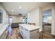 The kitchen island offers seating, storage, and prep space with a view to the living area at 853 E Ivanhoe Ct, Gilbert, AZ 85295