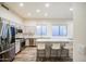Contemporary eat-in kitchen with stainless appliances, center island, bar stool seating and sleek countertops at 853 E Ivanhoe Ct, Gilbert, AZ 85295