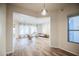 Bright, open-concept living room with hardwood floors and large windows providing natural light at 853 E Ivanhoe Ct, Gilbert, AZ 85295