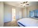 Neutral main bedroom featuring carpet, ceiling fan and a large window to the outdoors at 853 E Ivanhoe Ct, Gilbert, AZ 85295