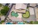 Aerial view of a backyard featuring a custom pool, putting green, and covered patio at 910 S Crossbow Ct, Chandler, AZ 85225