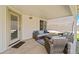 Covered back porch with comfortable seating for outdoor living and relaxation in the backyard at 910 S Crossbow Ct, Chandler, AZ 85225