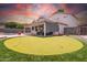 Well-manicured backyard with covered patio, putting green, and thoughtfully designed landscaping at 910 S Crossbow Ct, Chandler, AZ 85225